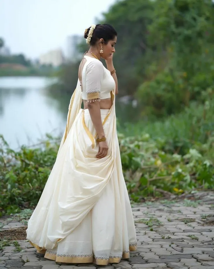 Hot image of Rashmi Gautam wearing a white outfit near water