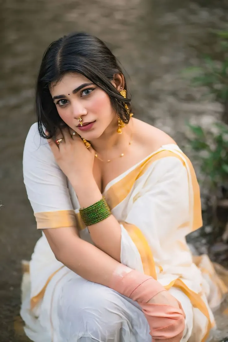 Hot woman in an Onam saree hand on her shoulder wallpaper