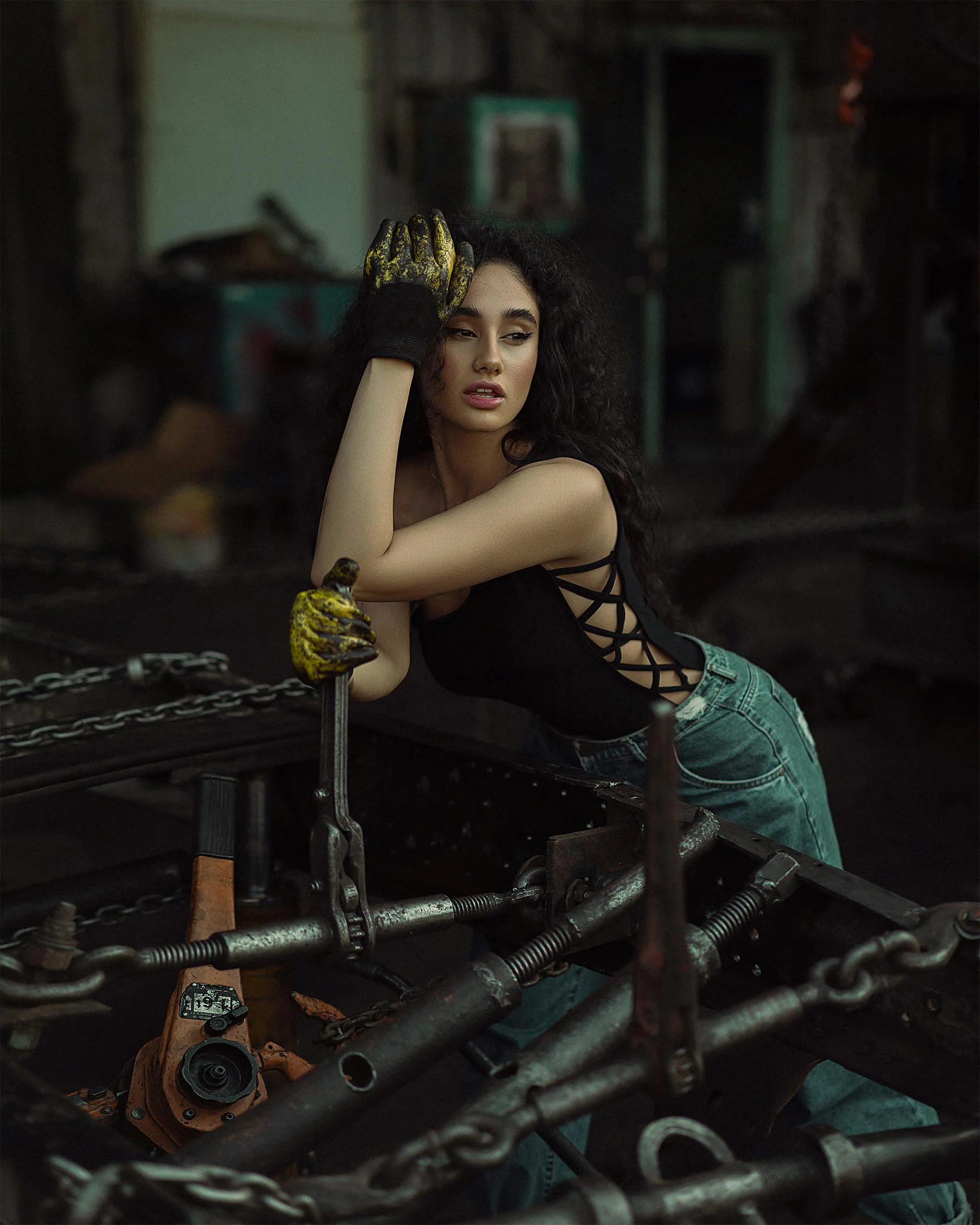 Industrial Themed Model Posing Among Chains and Tools View