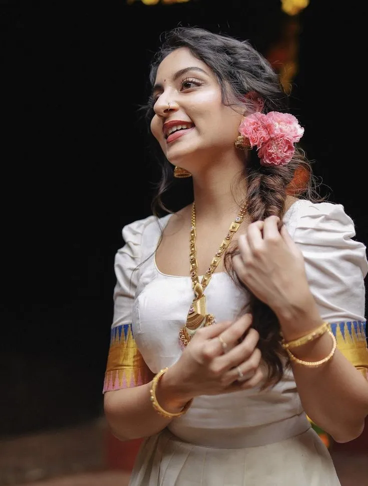 Ishaani Krishna in traditional Kerala dress with pink flower