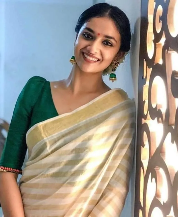 Keerthy Suresh in a white saree with a green jacket image
