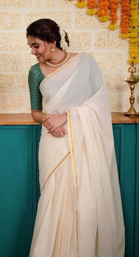 Keerthy Suresh in a white saree with a looking down pose