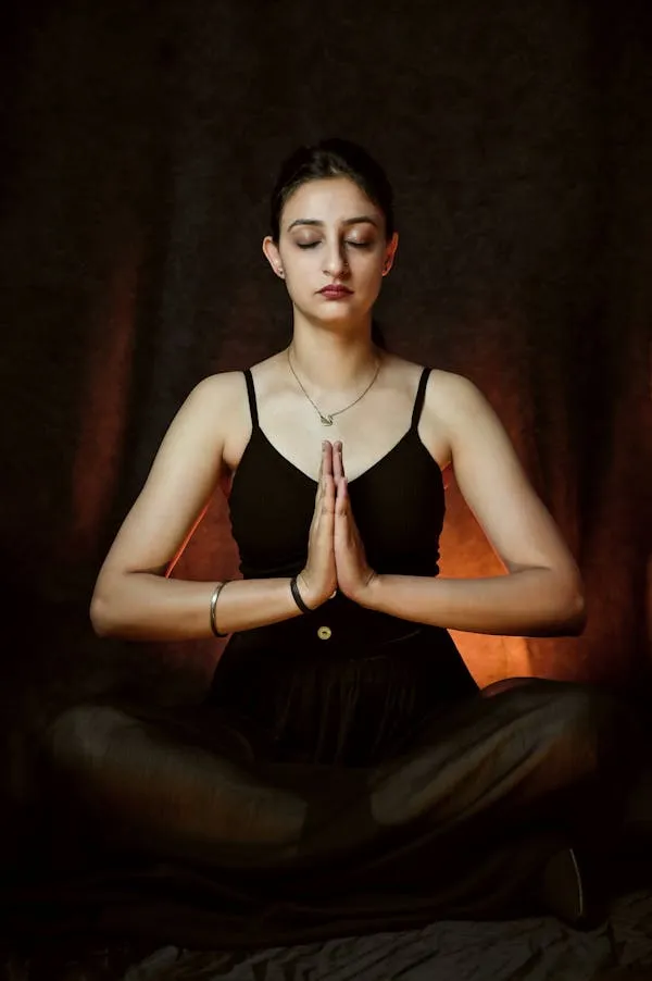 Meditating Woman Sitting Cross Legged with Eyes Closed Image