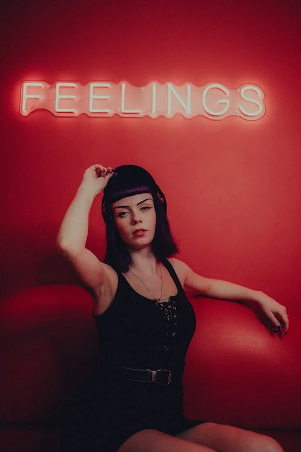 Model Posing with Hand on Face Under a Red Feelings Sign