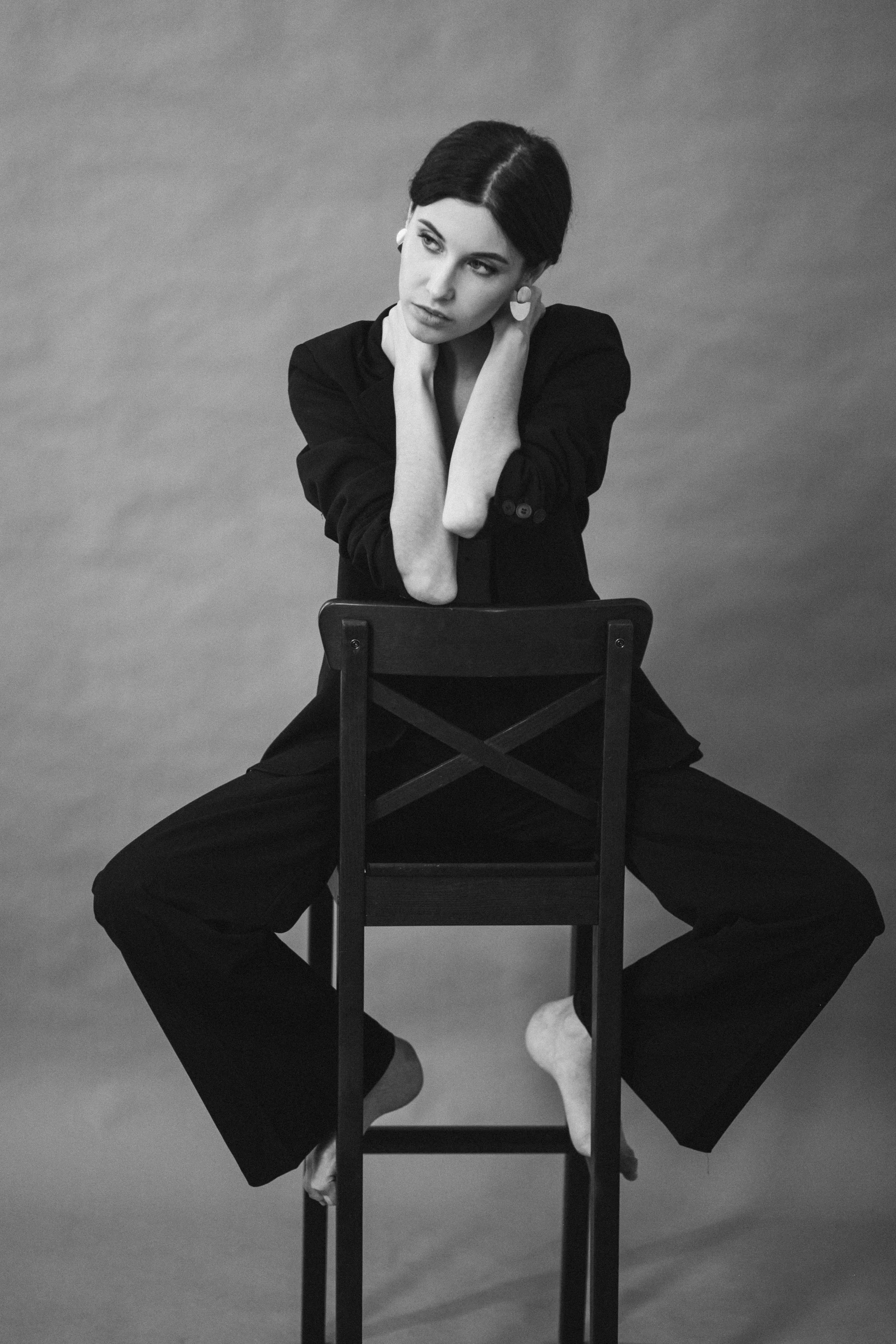 Monochrome Image of a Woman Sitting on Tall Chair Wallpaper