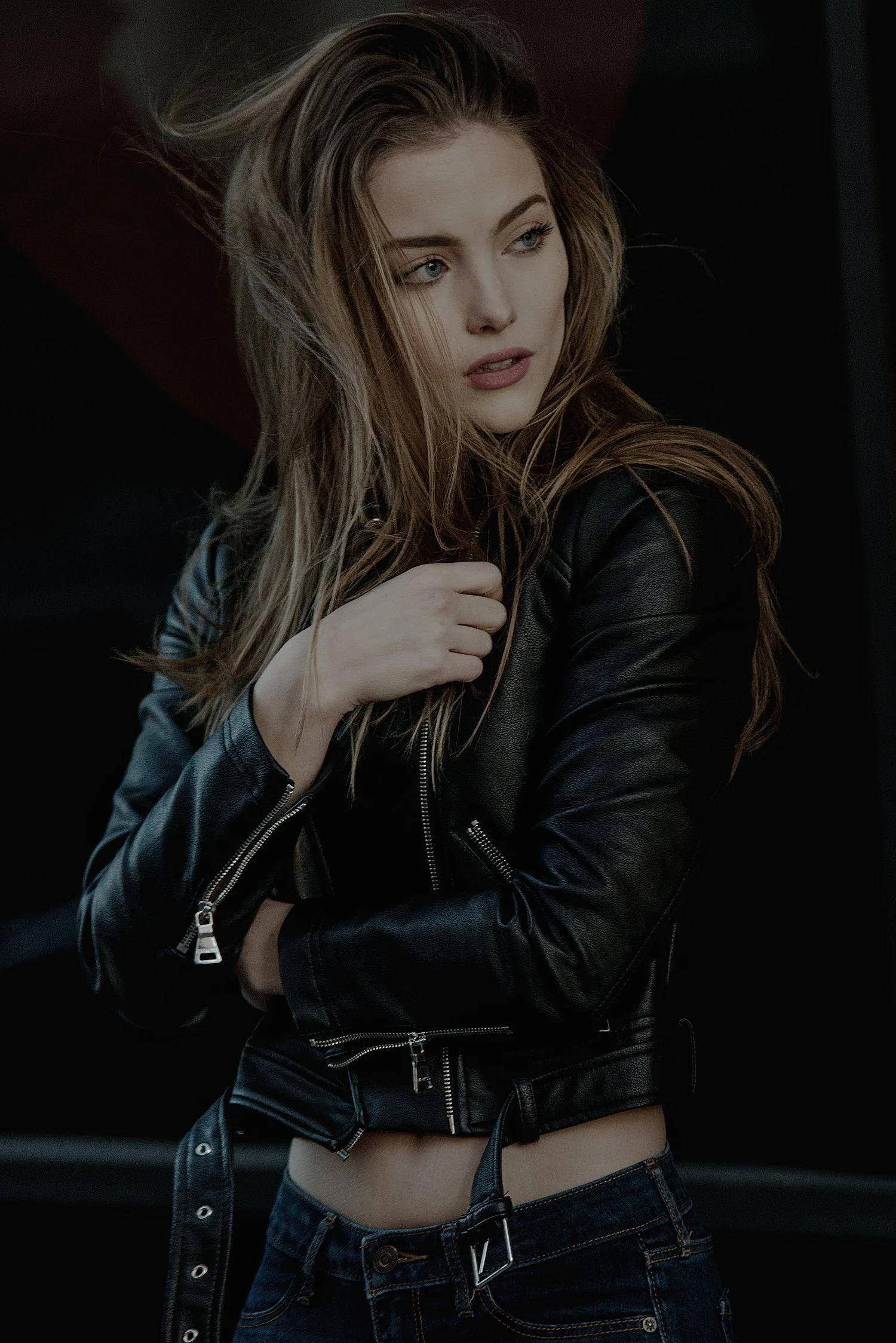Moody Portrait of a Woman in a Leather Jacket At Night Image