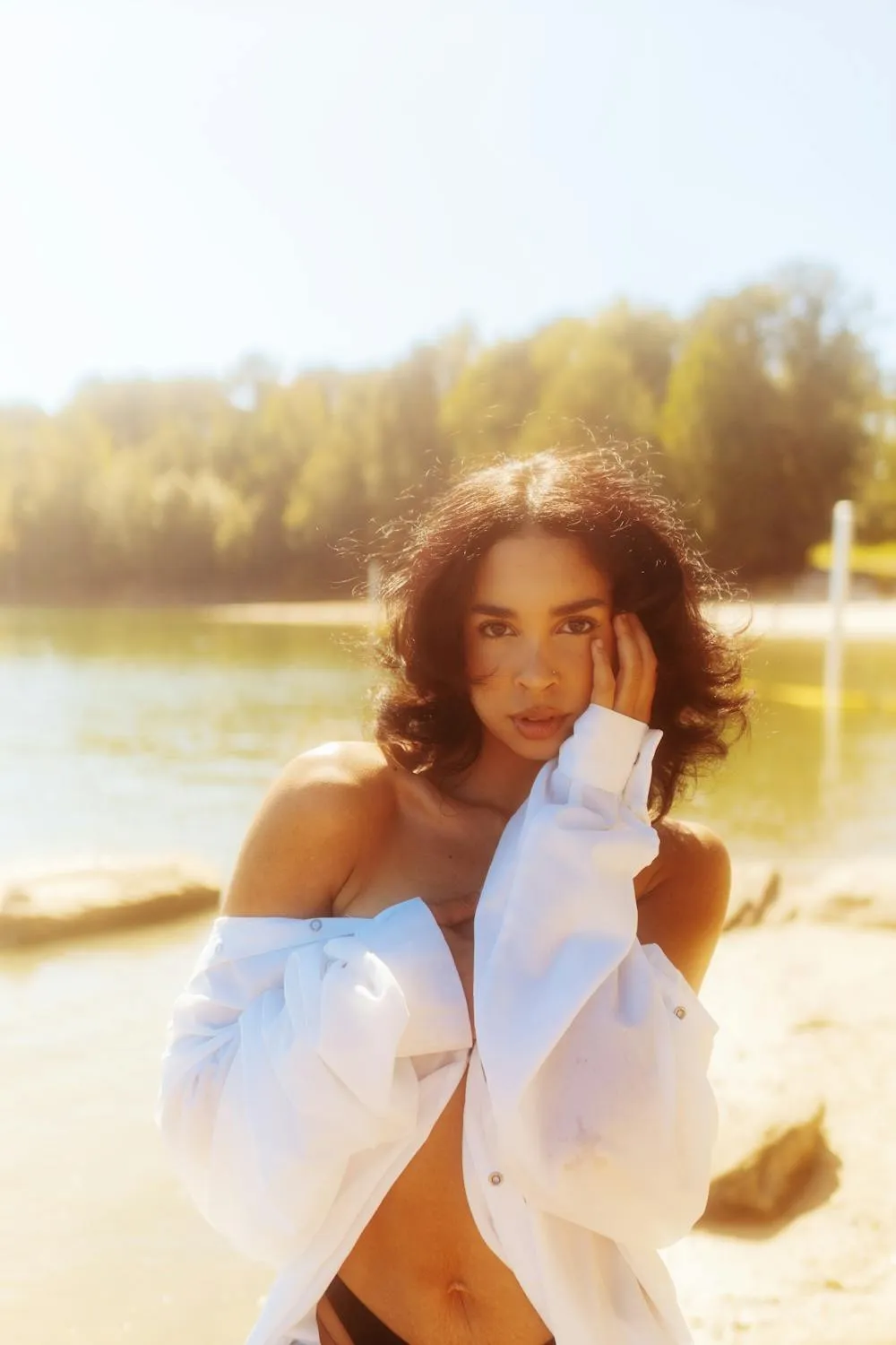 Natural Light Photo of Woman with Curly Hair in White Shirt