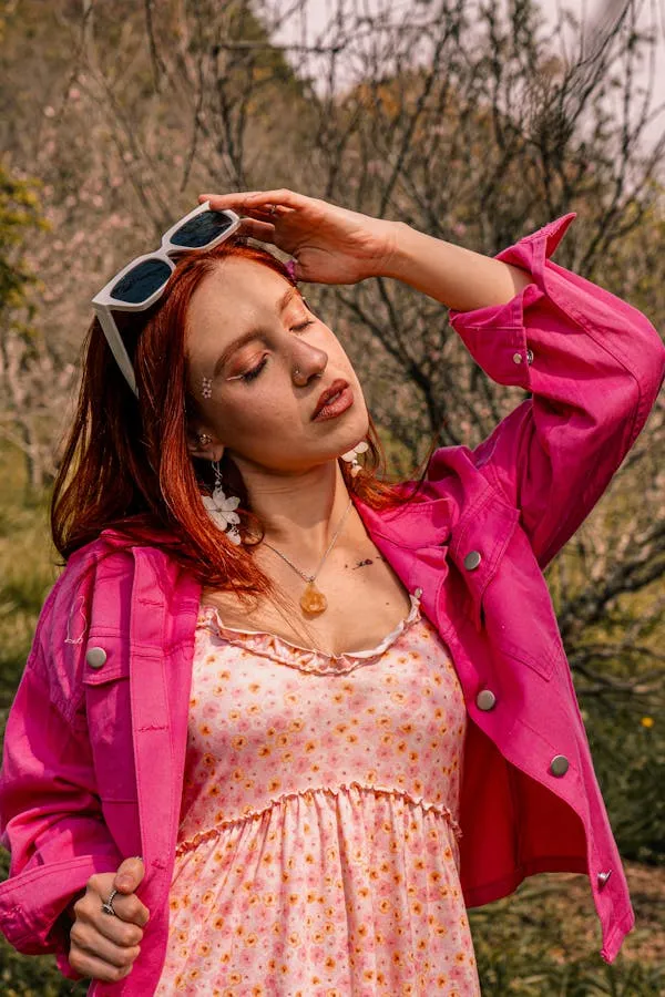 Outdoor Image of a Woman with Sunglasses and a Pink Jacket