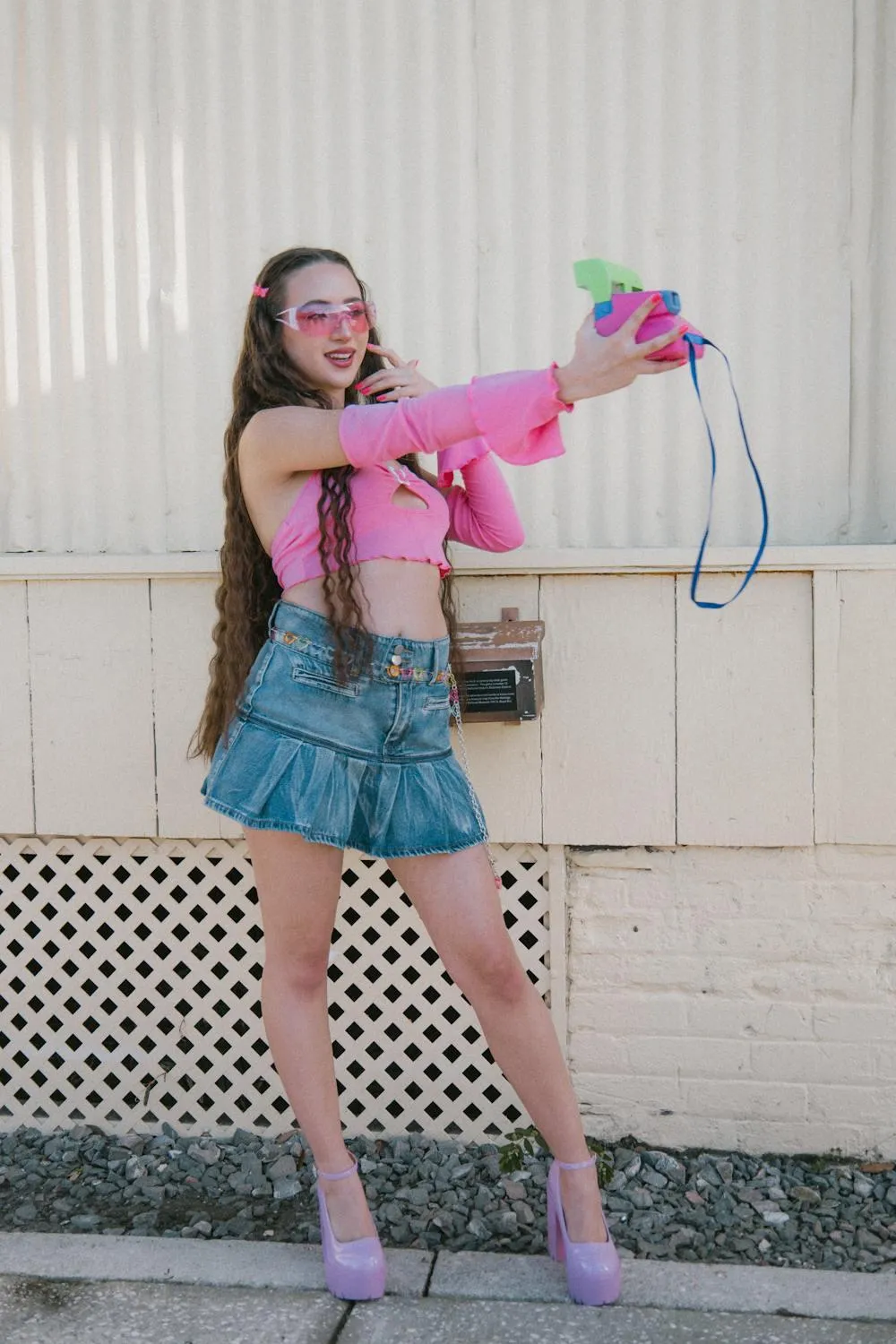Playful Woman in a Colorful Outfit Holding Pink Boombox