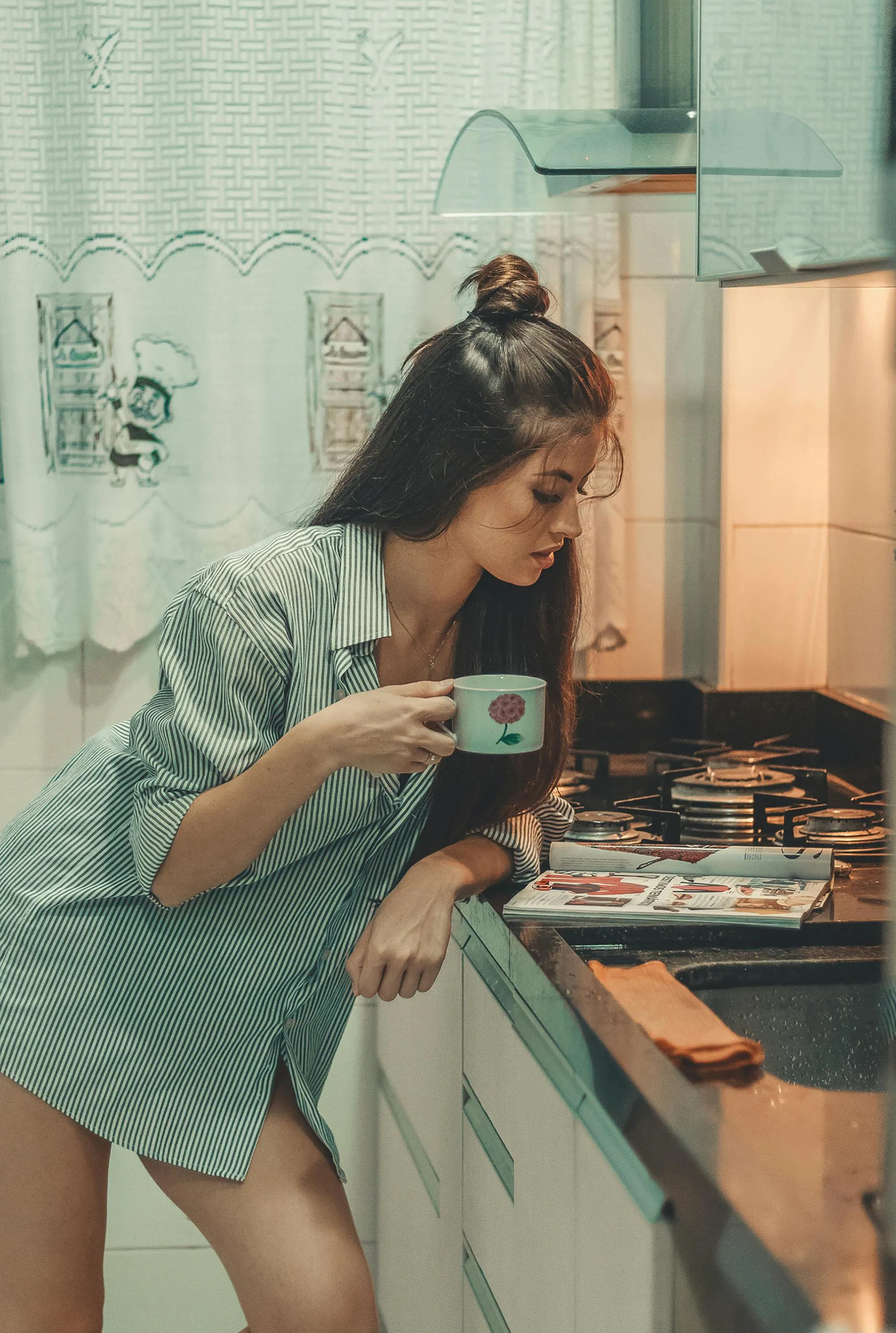 Playful Woman in the Kitchen Posing in an Oversized Shirt