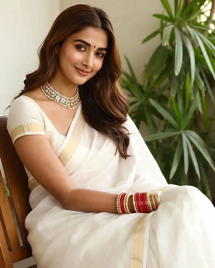 Pooja Hegde in an Onam dress sitting on the chair wallpaper