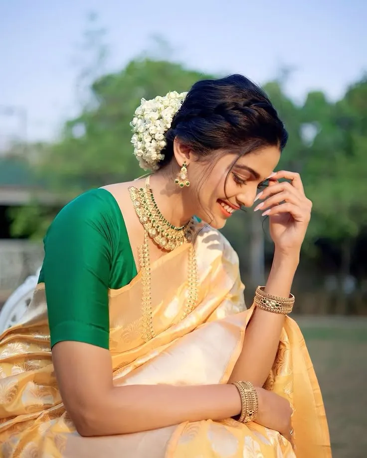 Pooja Sawant in a traditional Onam saree with green blouse