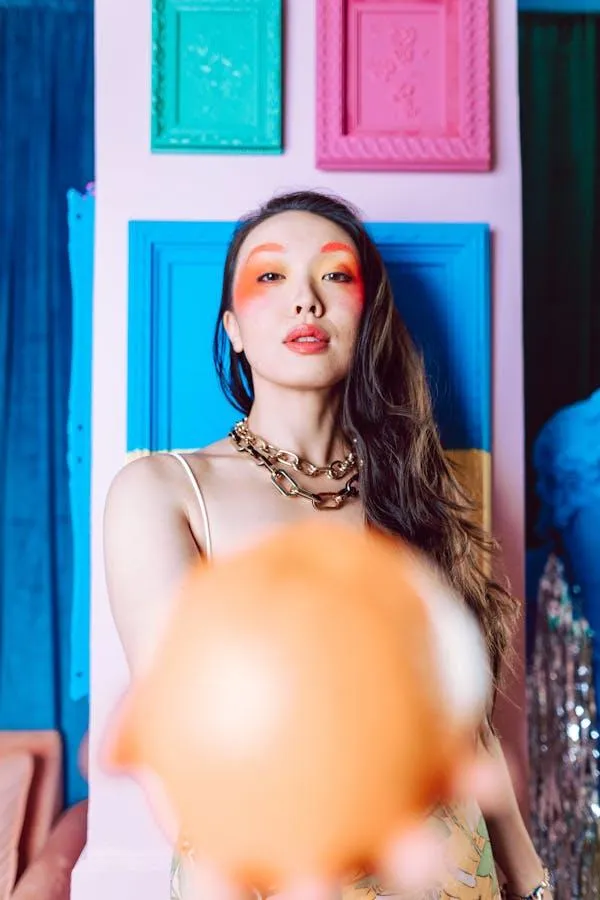 Portrait of a Woman Holding a Peach Balloon Free Wallpaper