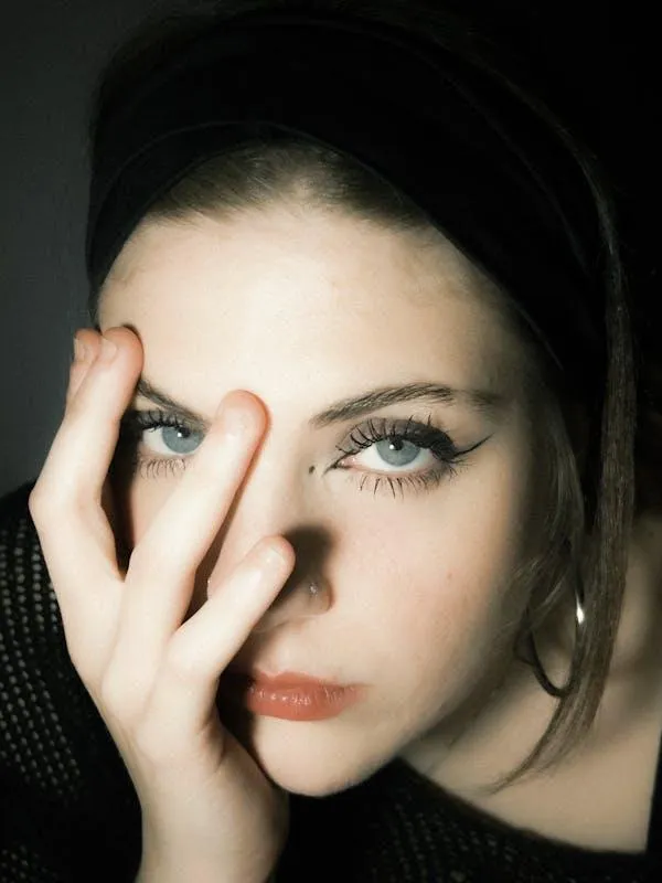 Portrait of Woman Partially Covering Her Face with Her Hand