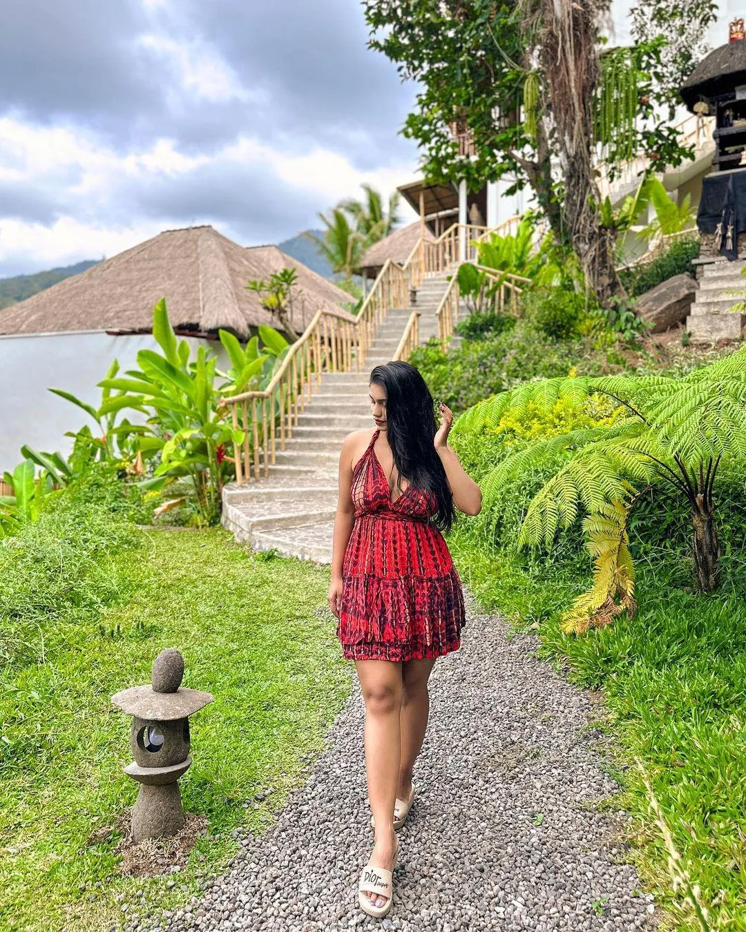 Pratika Sood in Red Dress Posing on Green Garden Path Image