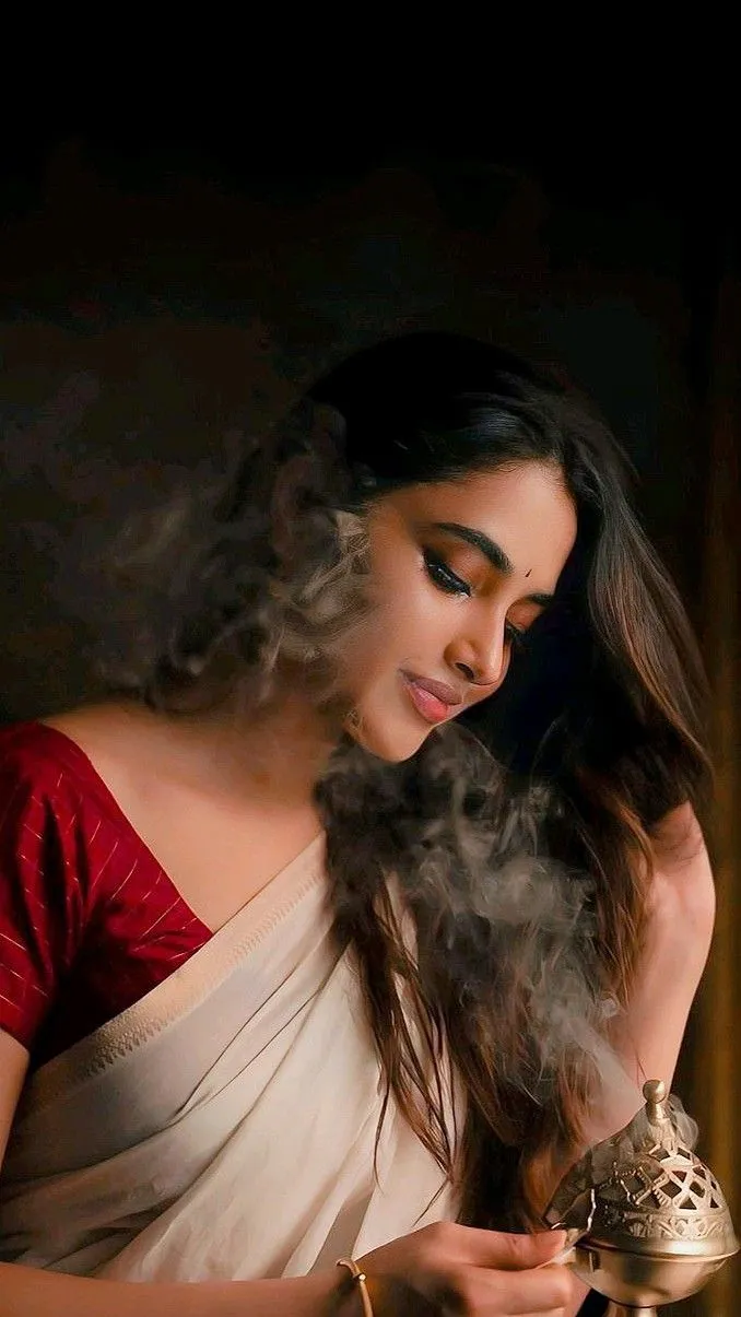 Priyanka Mohan in saree with red blouse holding loban burner