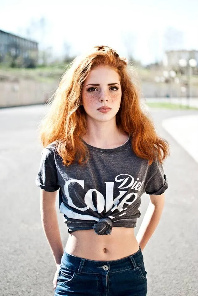 Redhead Woman Standing in the Street Wearing a Crop Top