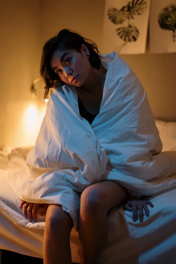 Relaxing Indoor Portrait of a Woman Wrapped in White Blanket