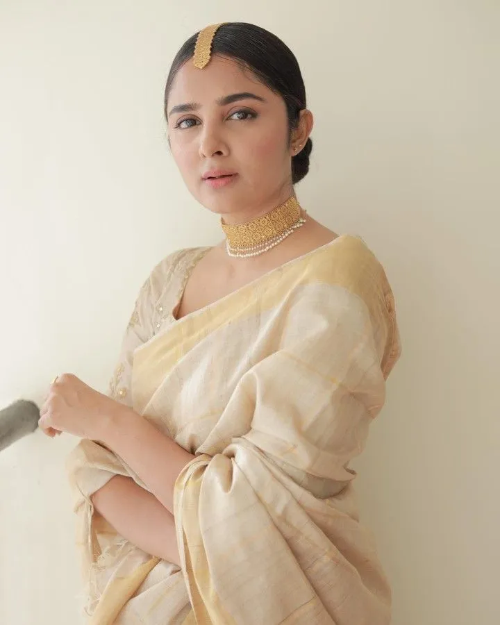 Reshma Sebastian at the Onam function standing near a wall