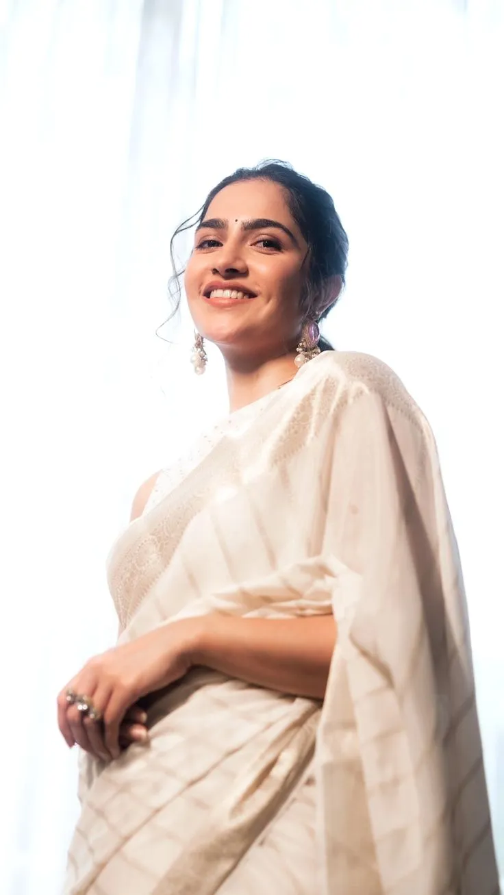 Rukmini Vasanth in a Kerala saree standing in bright light