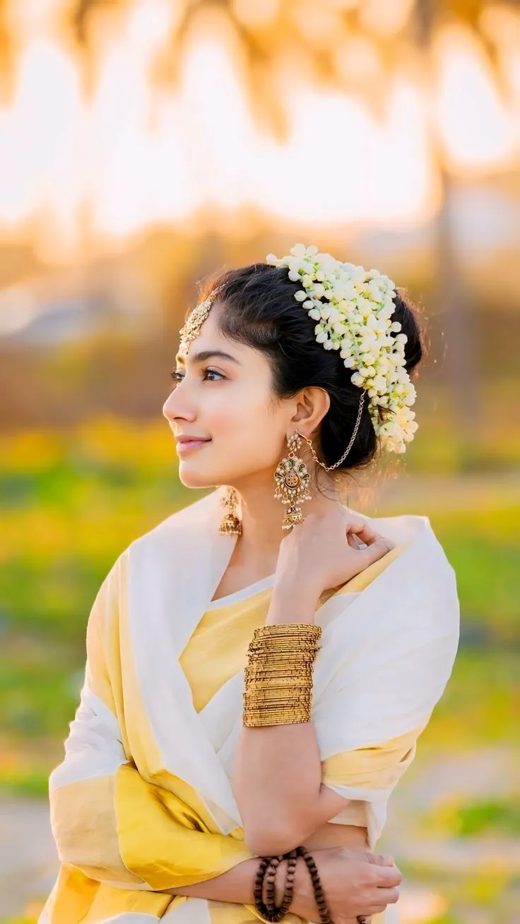 Sai Pallavi in a traditional Kerala saree under the sunlit