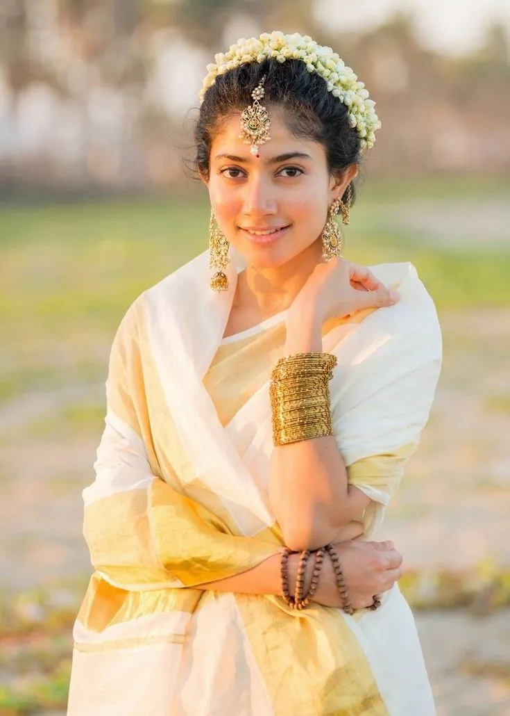 Sai Pallavi in traditional white saree with jasmine flowers