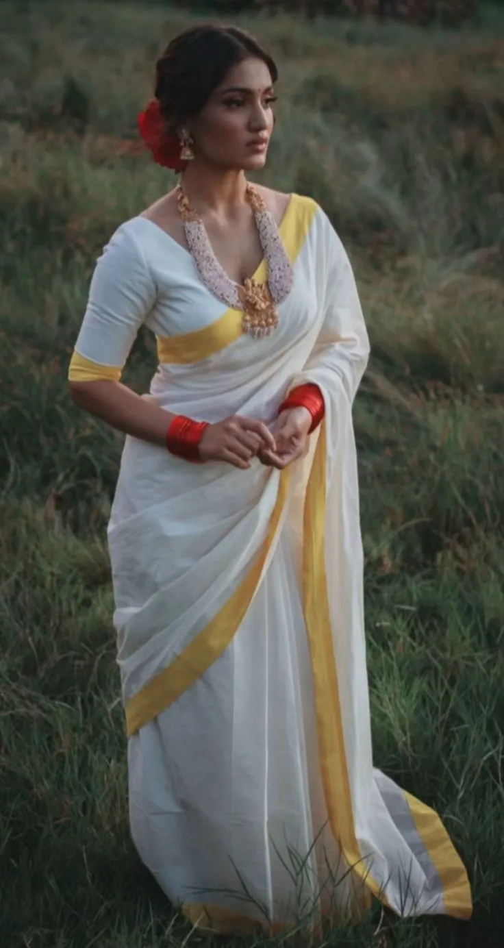 Saniya Iyappan in a Kerala saree standing grass field image
