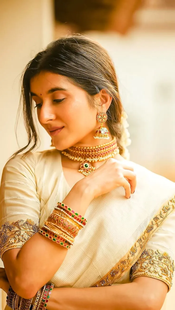 Sanjana Sarathy looking sideways wearing a Kerala saree