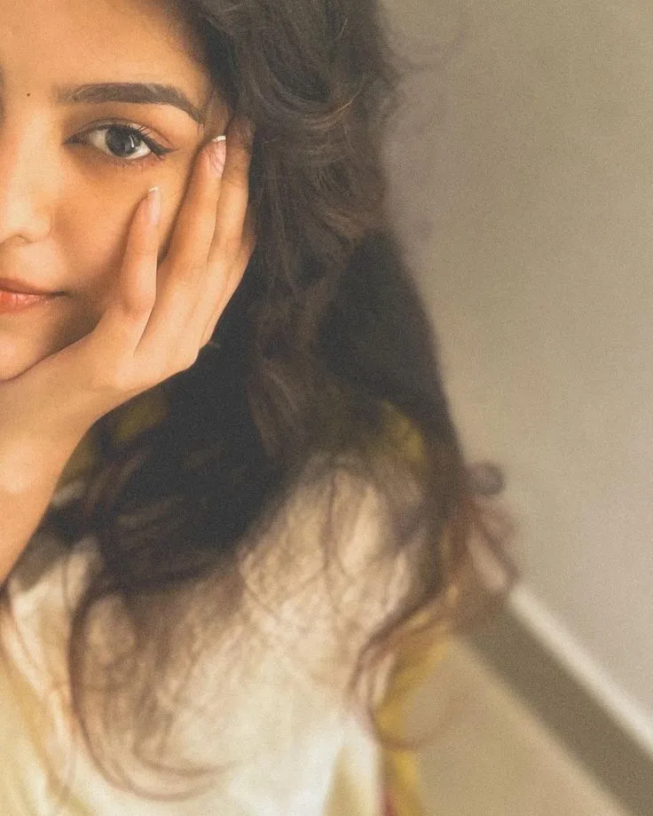 Selfie image of a beautiful woman with her hand on her cheek