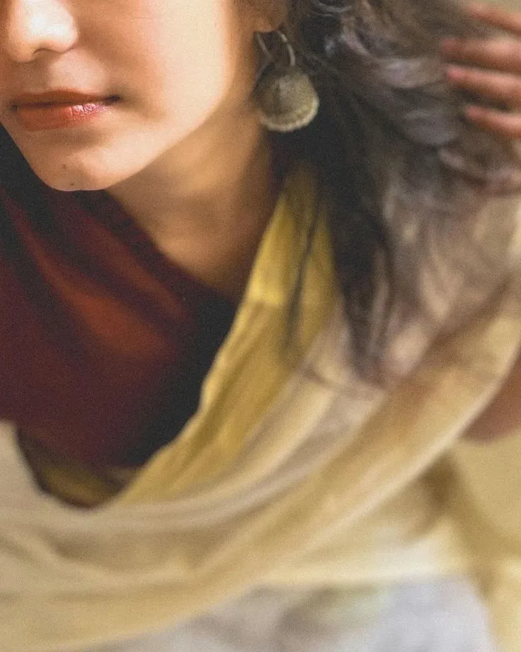 Selfie image of a young woman wearing a white nerial saree