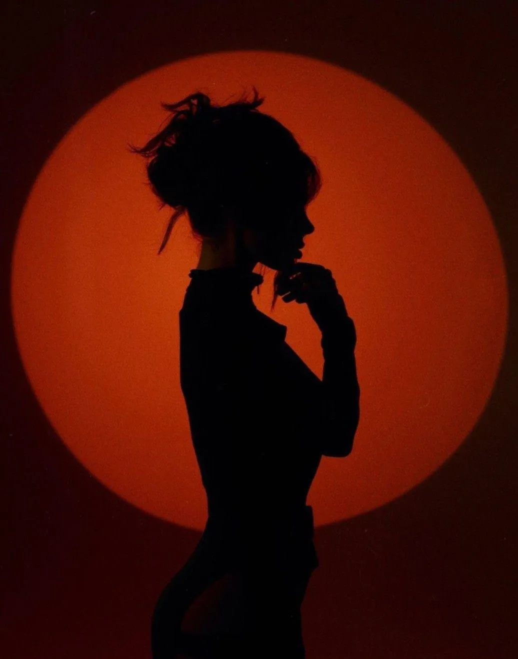 Silhouette of a Woman in Front of a Bold Red Circle Light
