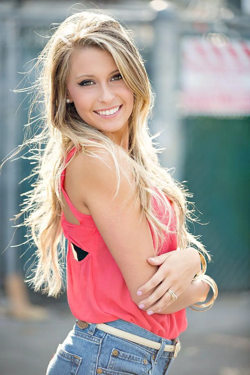 Smiling Blonde Model Posing in a Pink Top with Confidence