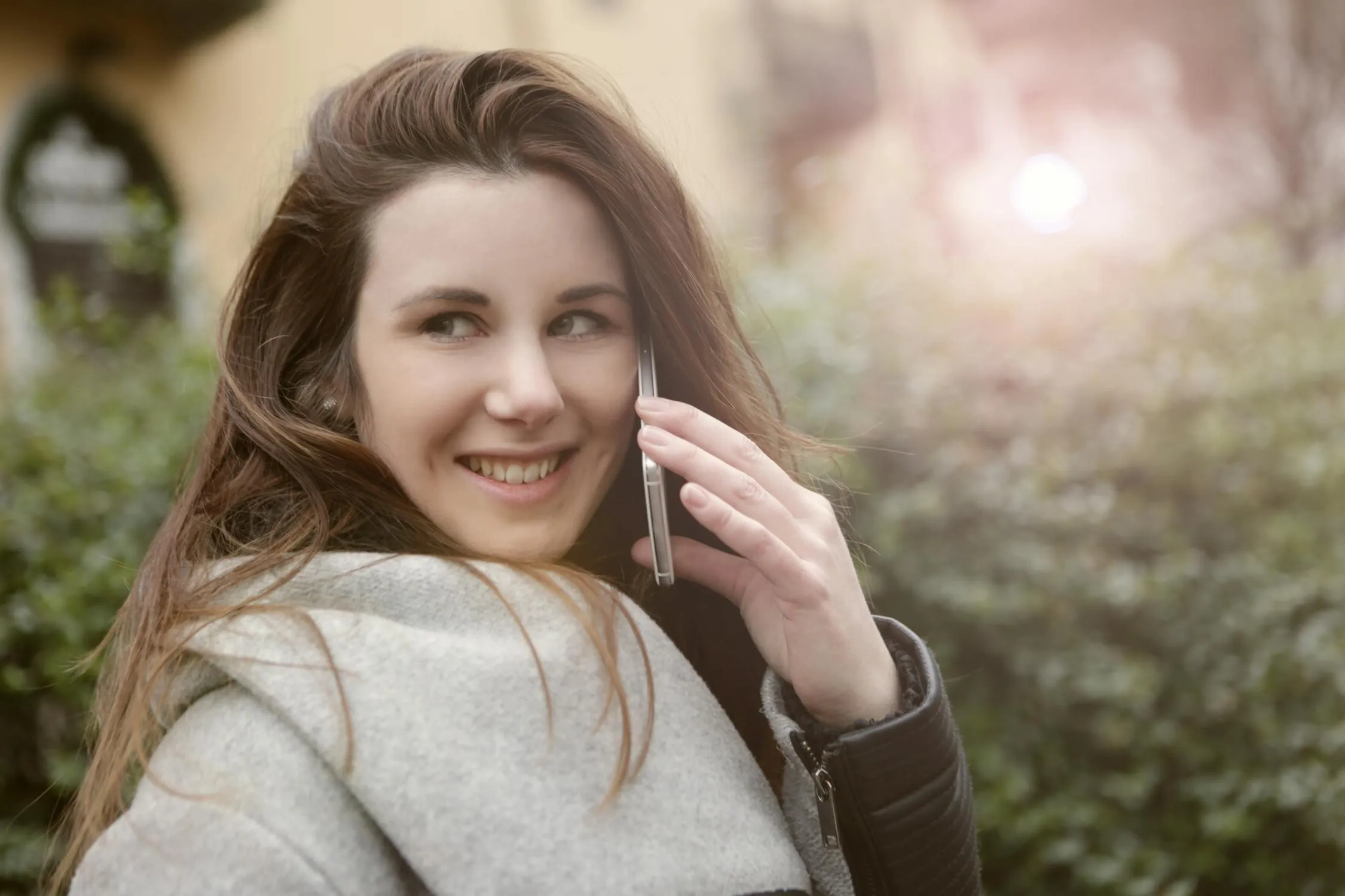 Smiling Girl in a Natural Setting with Soft Glowing Light