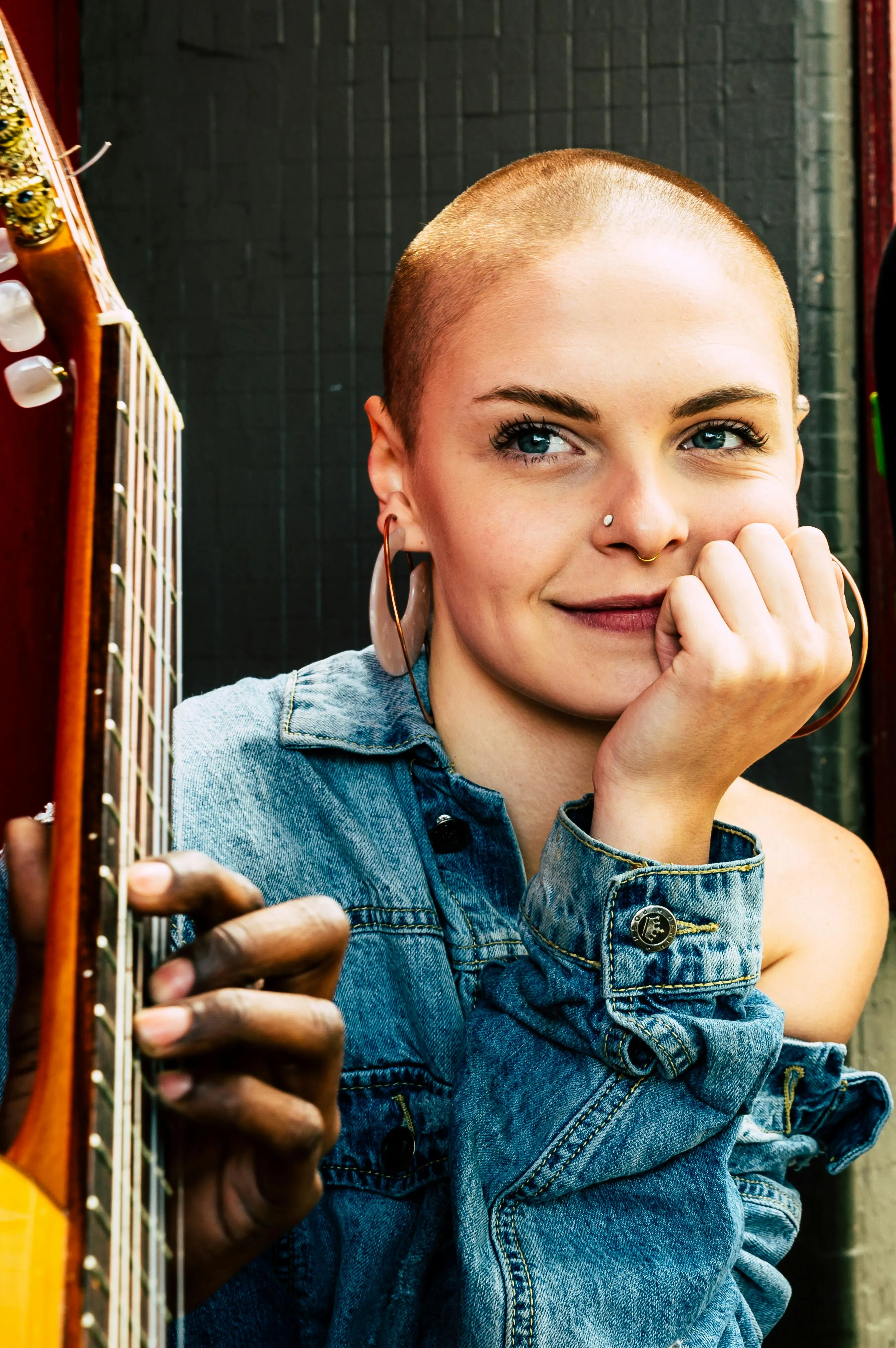 Smiling Woman Leaning on the Door Frame in a Casual Outfit