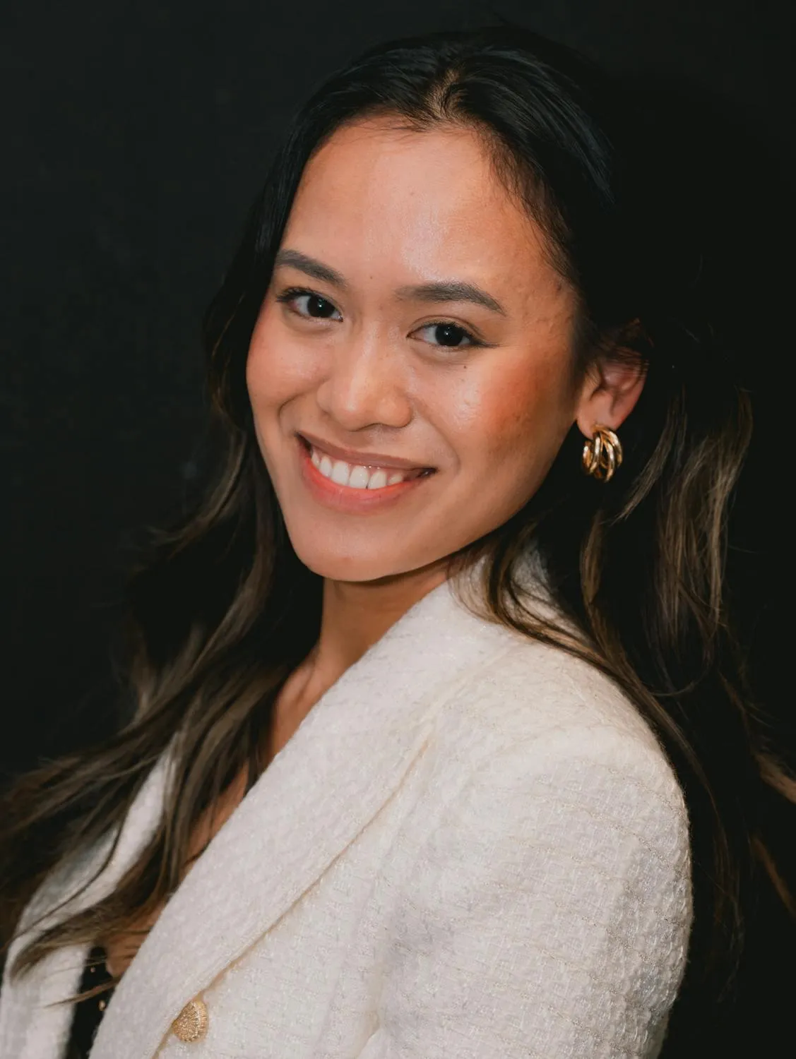 Smiling Woman in White Jacket with Long Dark Hair Wallpaper