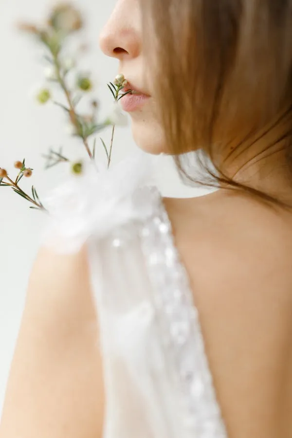 Soft Close Up of Woman with Flowers Near Her Face Wallpaper