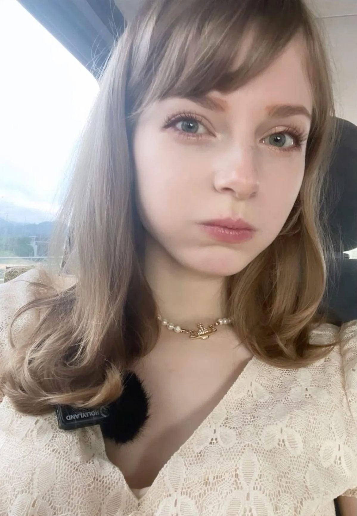 Soft Portrait of a Woman with Bangs in a White Lace Dress