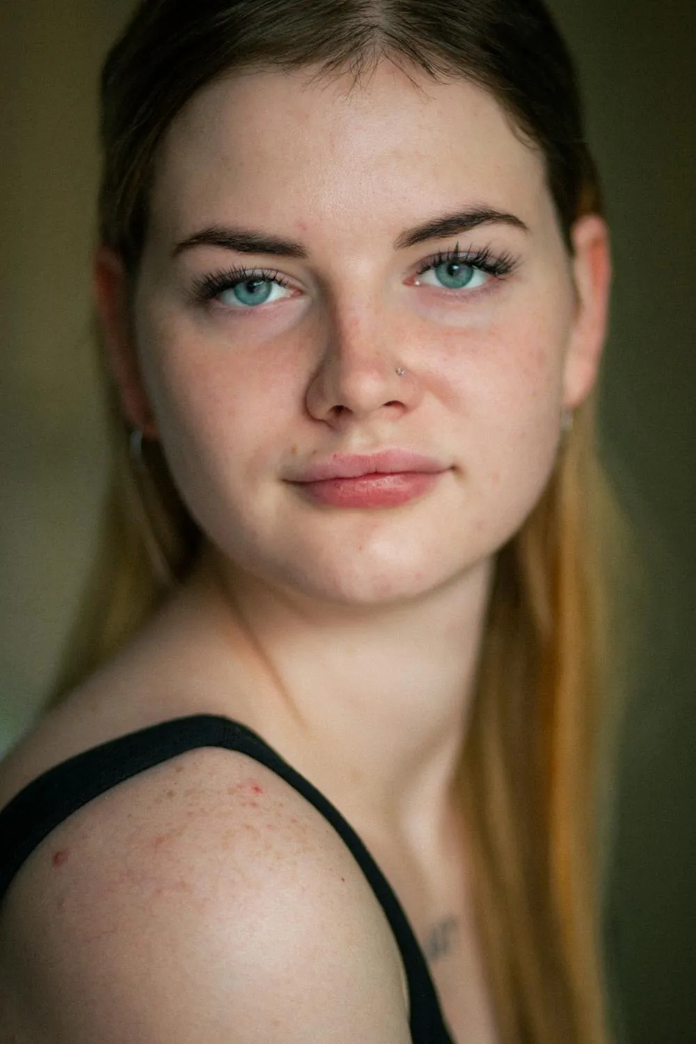 Soft Portrait of a Young Woman with a Slight Smile Posing