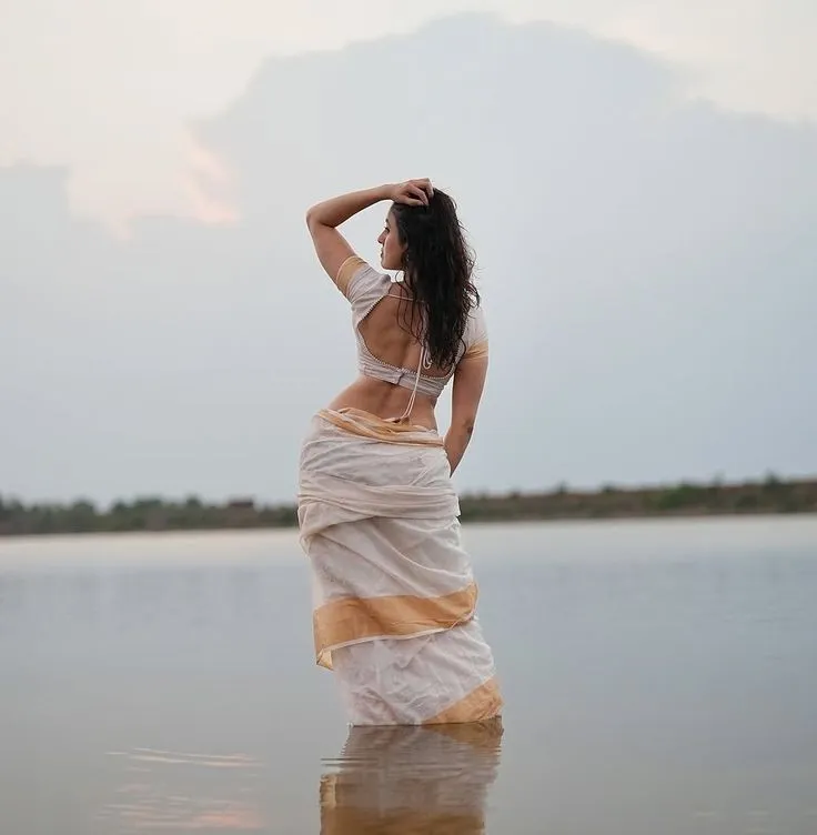 Stunning pose of a young woman standing in the water image