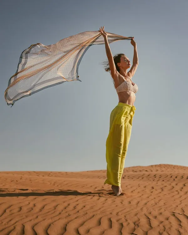 Stunning Woman in the Desert Holding Fabric in Windy Moment