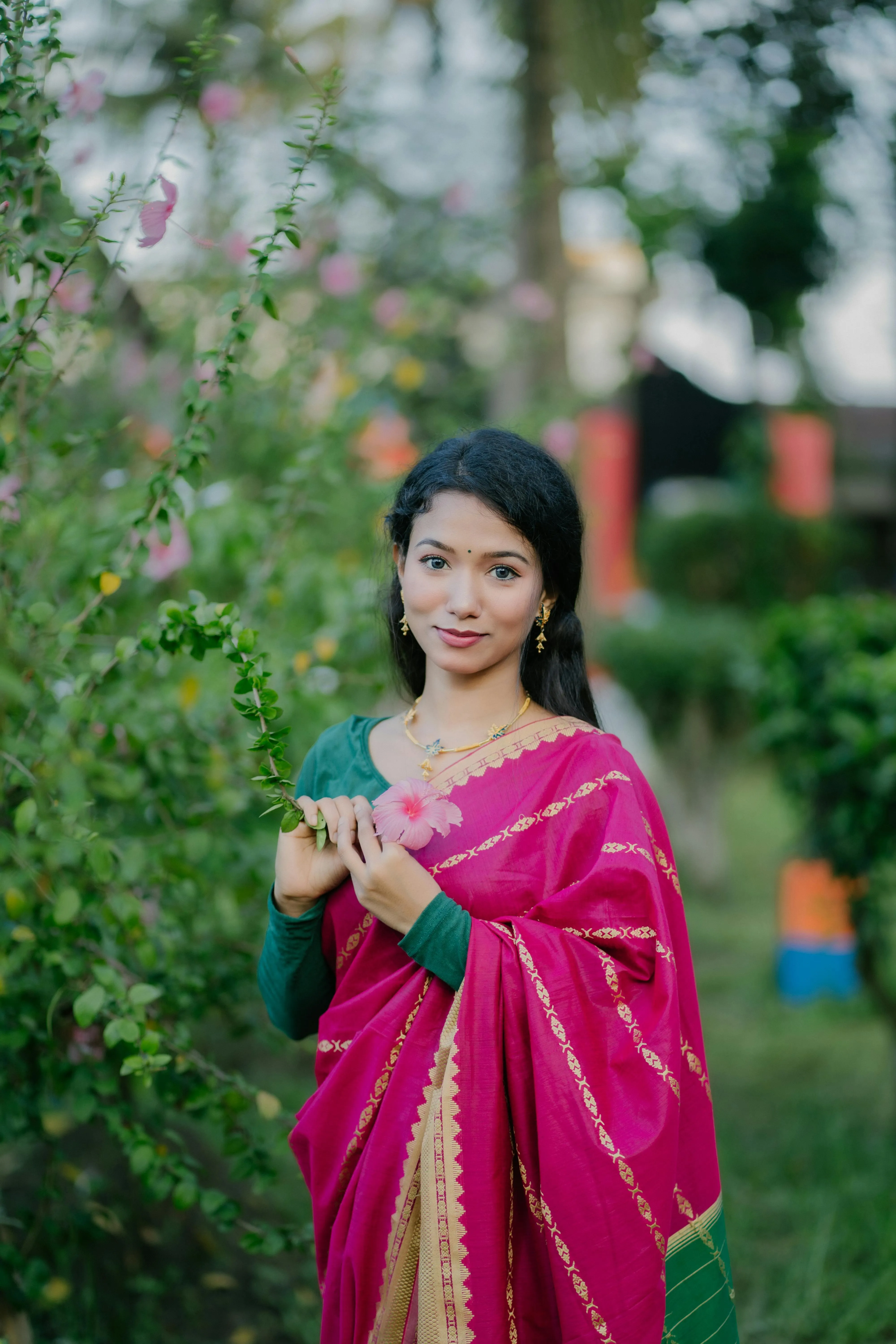Stunning Young Woman in Pink Saree Outdoor Garden Pose Image