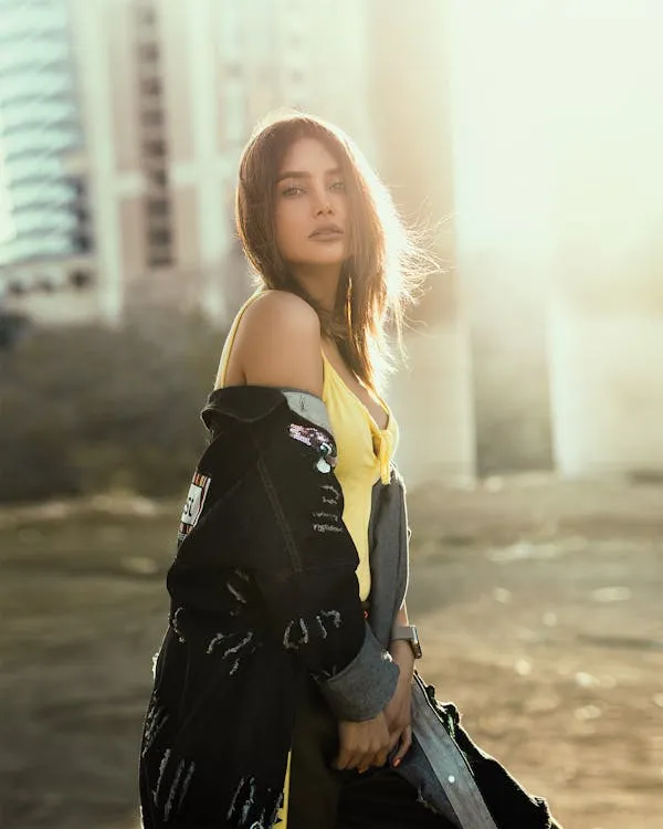 Stylish Urban Model with Jacket Standing in Evening Sunlight