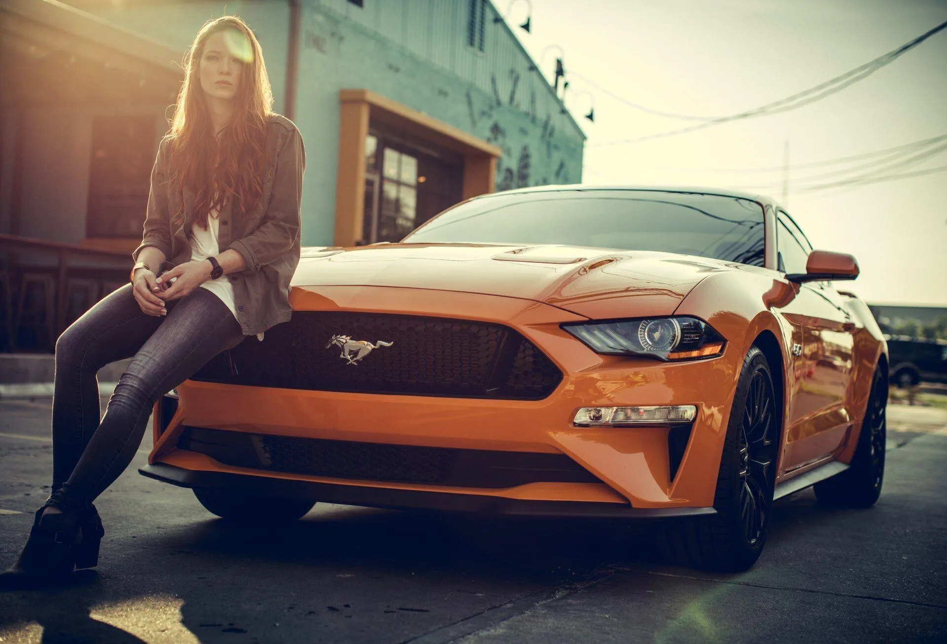 Stylish Woman Leaning on a Yellow Sports Car Free Wallpaper