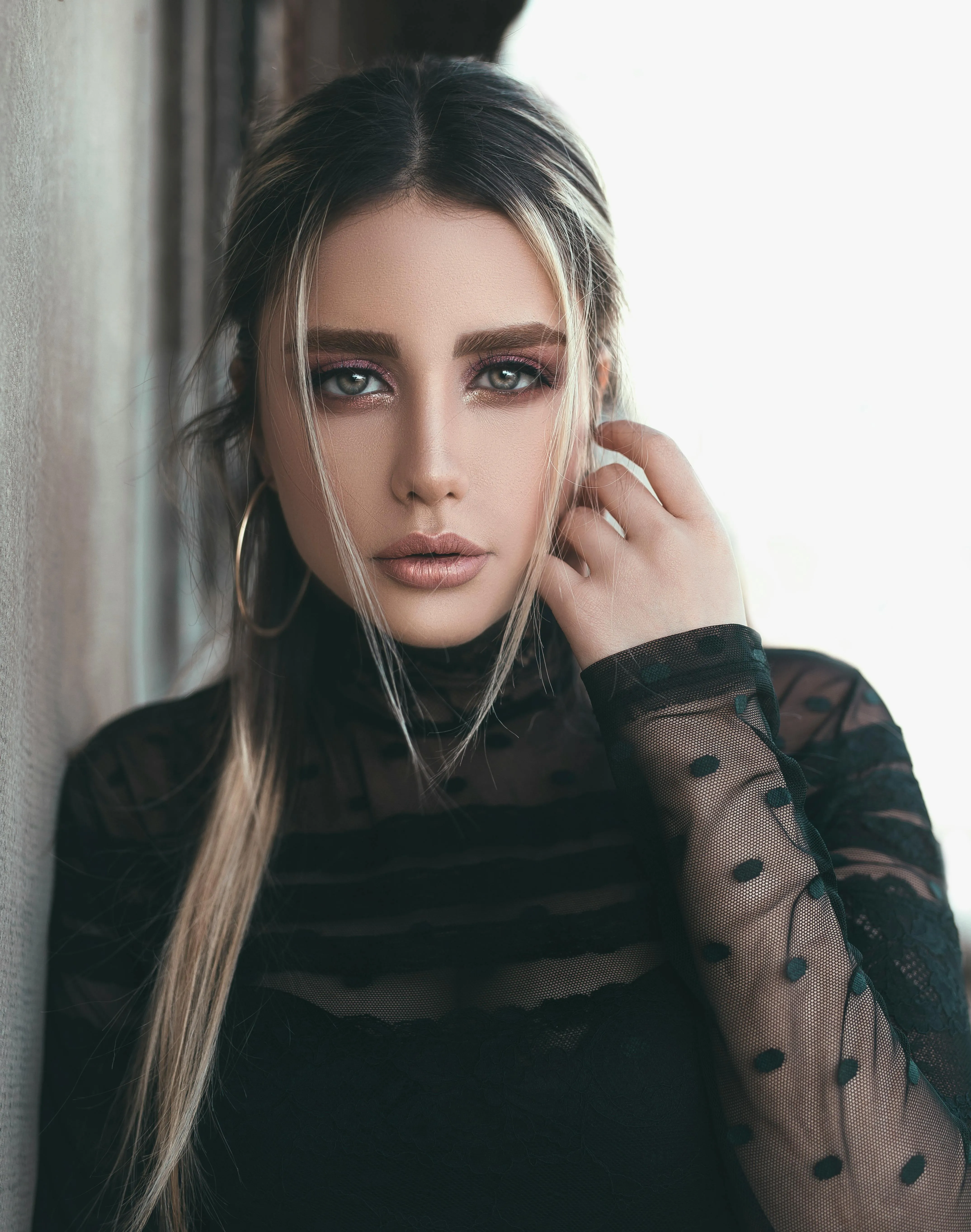 Stylish Woman in Sheer Black Top with Intense Smoky Eye Look