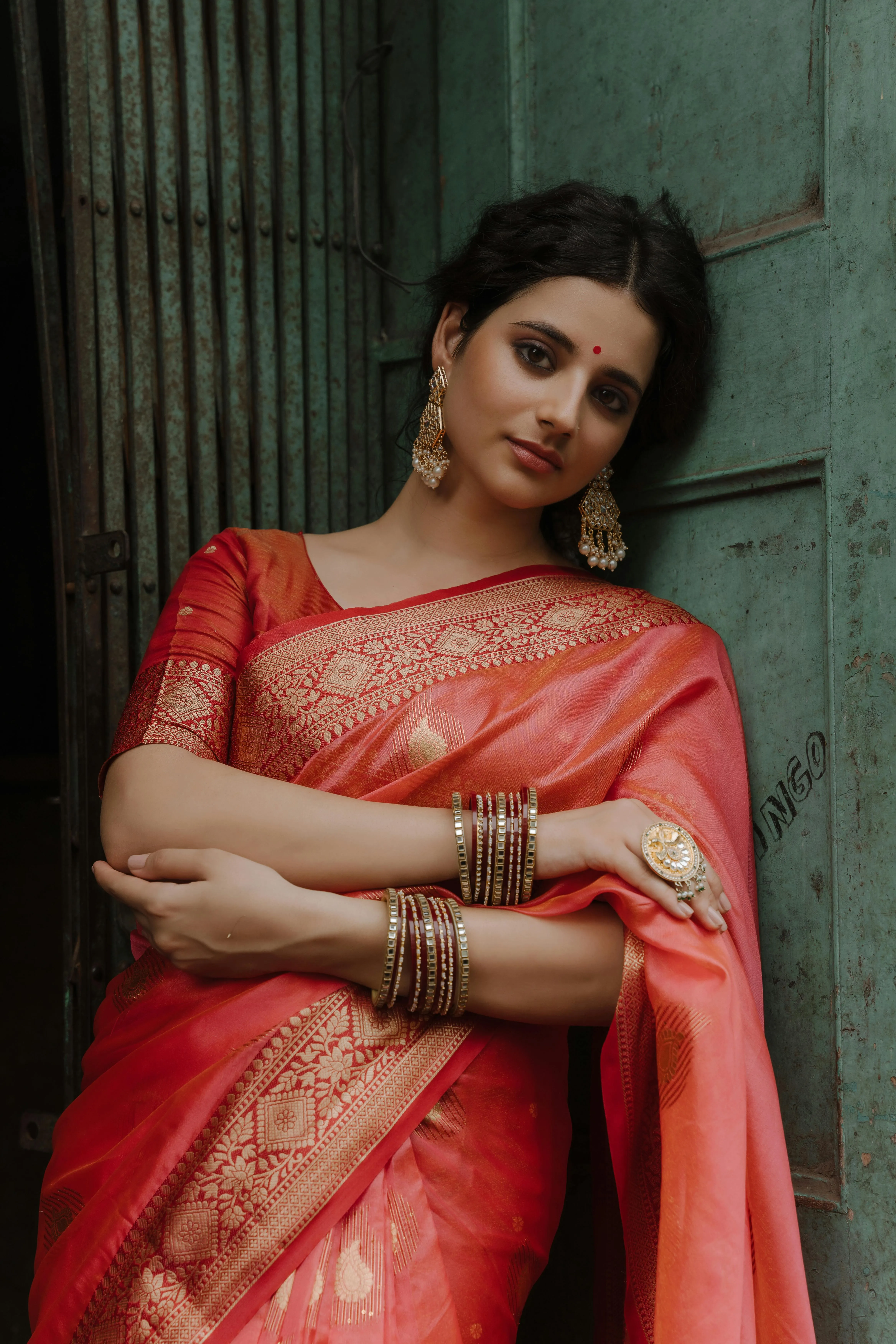 Sultry Young Woman in Red Saree Thoughtful Sitting Pose
