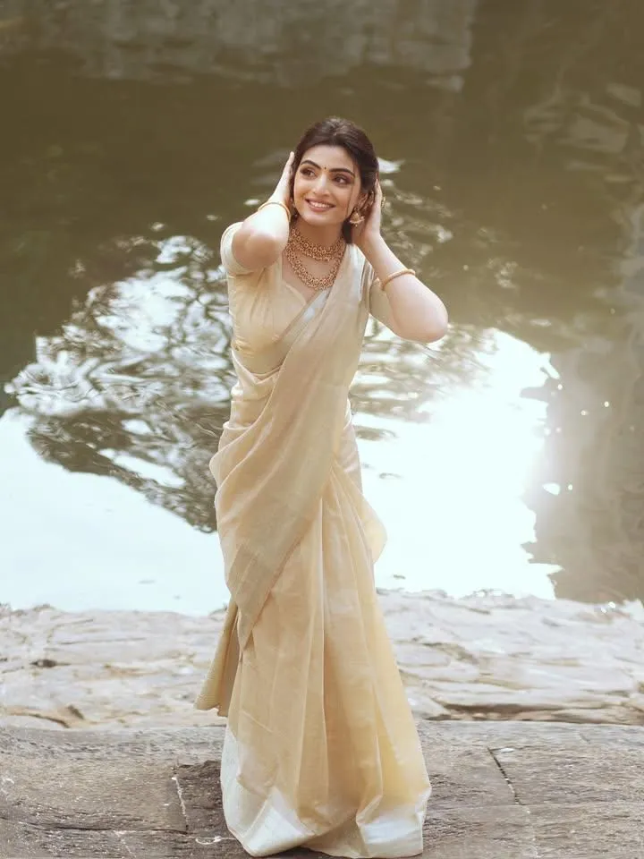 Swati Sharma in a traditional Kerala Onam saree near water