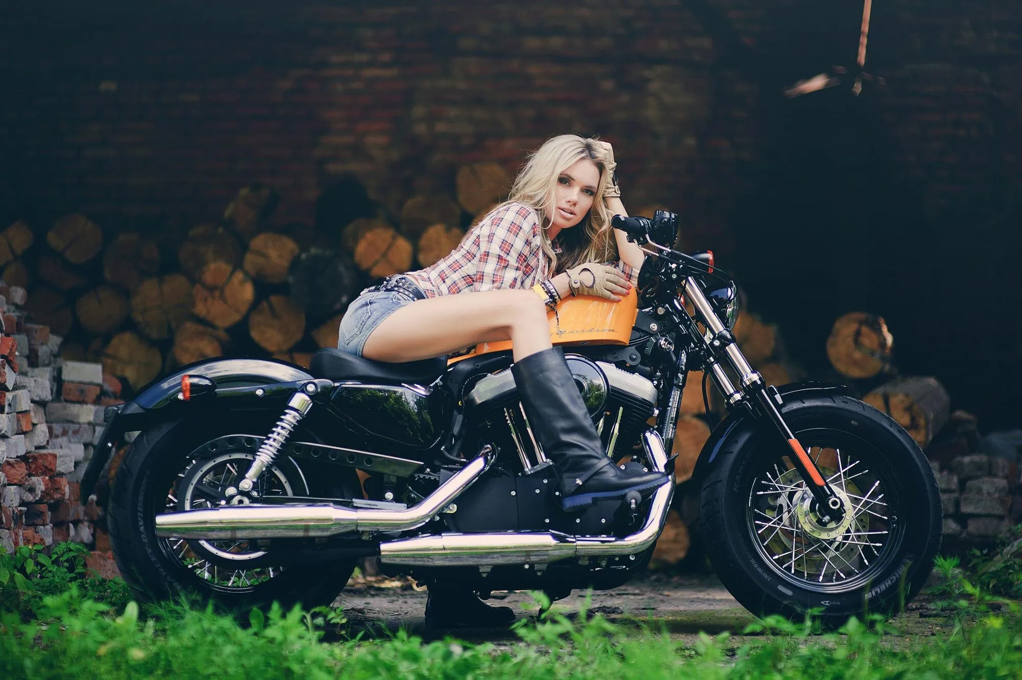 Tattooed Woman Sitting on a Custom Motorcycle in the City