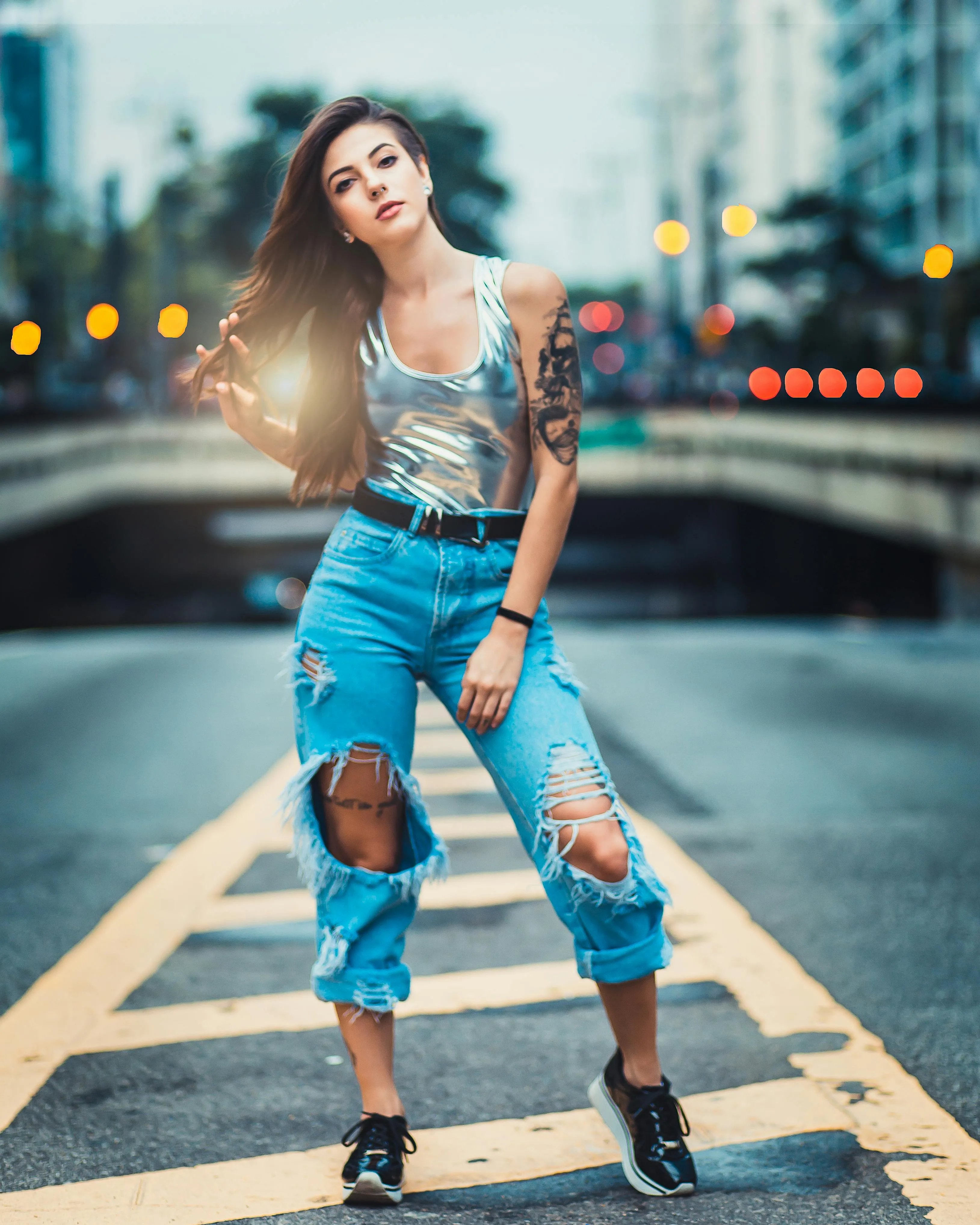 Tattooed Woman Standing Confidently on City Street Wallpaper