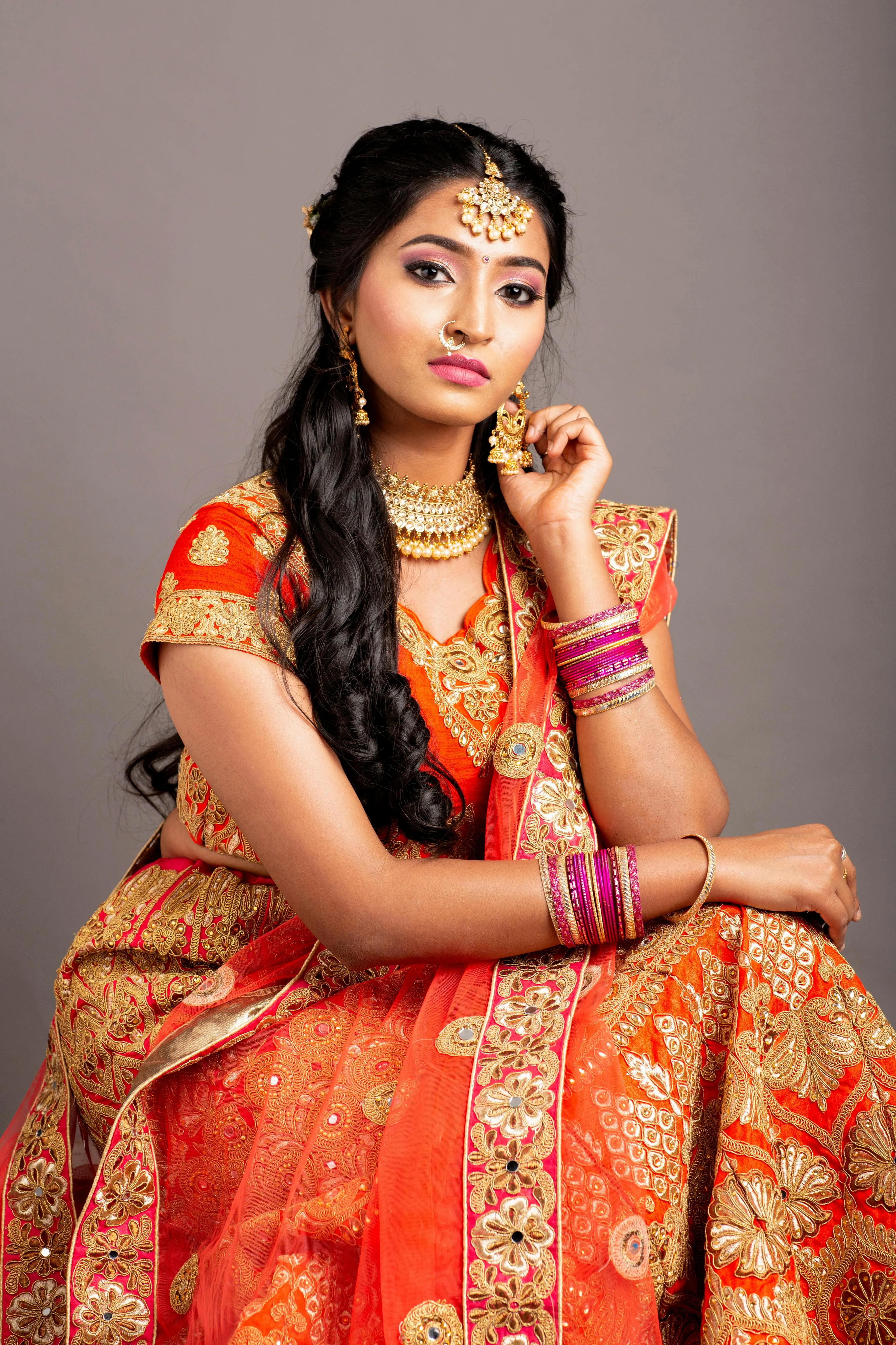 Tempting Young Woman in Red Saree Sitting Traditional Pose