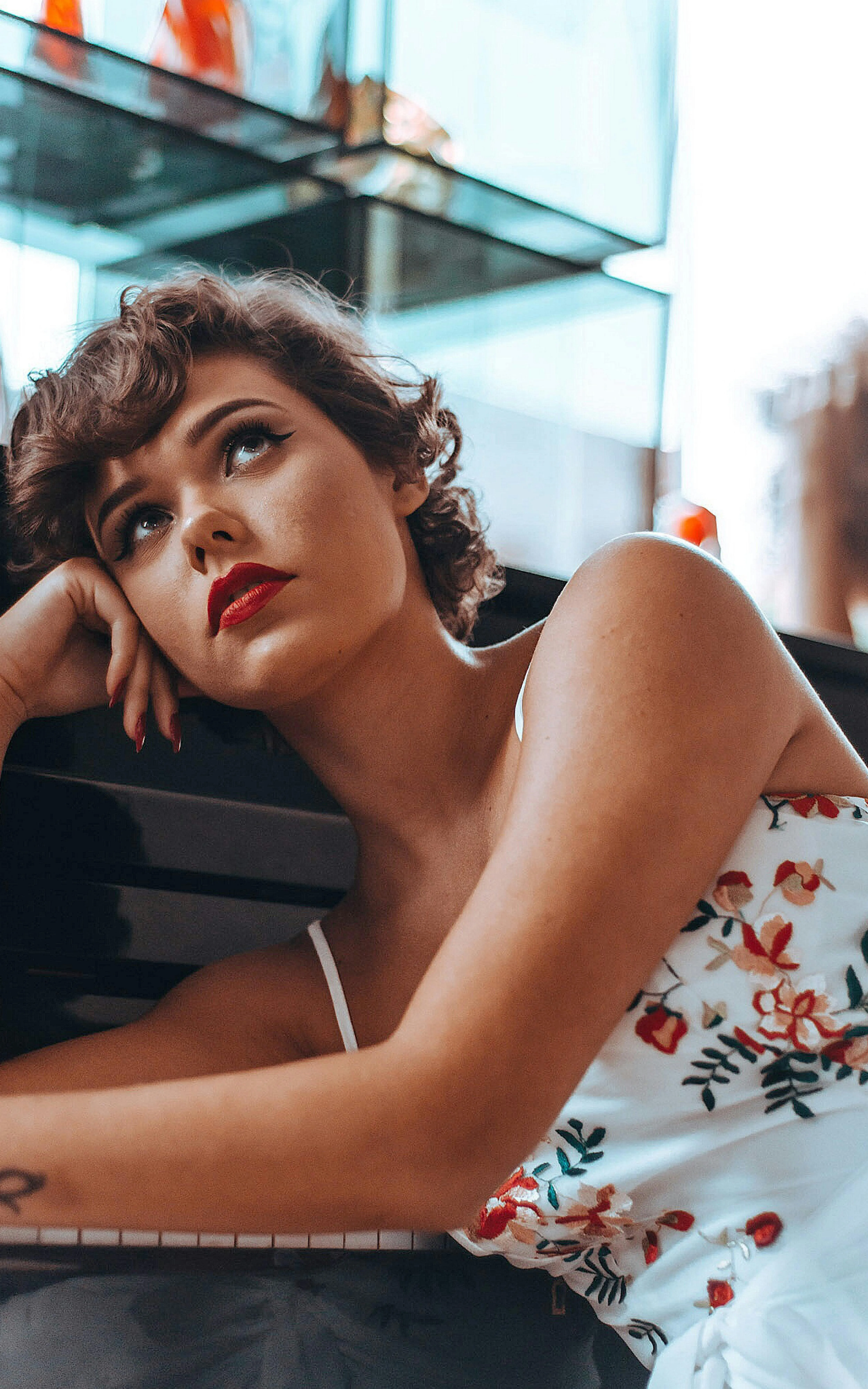Thoughtful Woman Resting Her Head on Arm Looking Out Window
